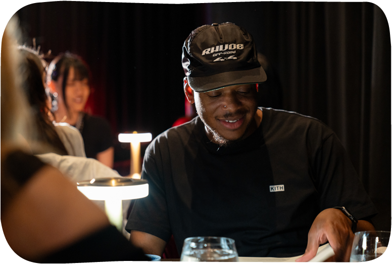 Man with cap and name tag at a social event