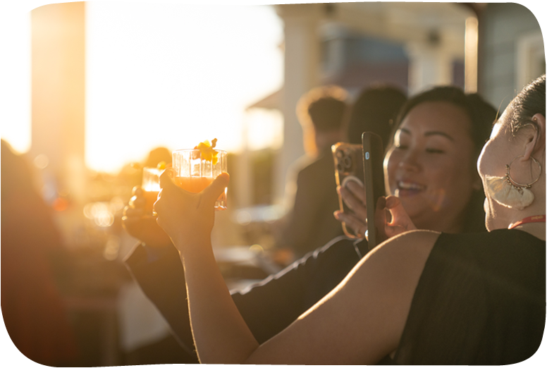 People enjoying drinks at sunset