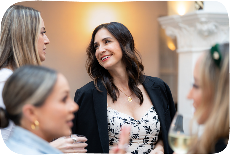 Woman with glasses in light blue top talking